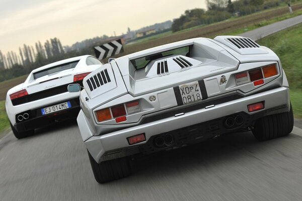 Supercars race outside the city, rear view