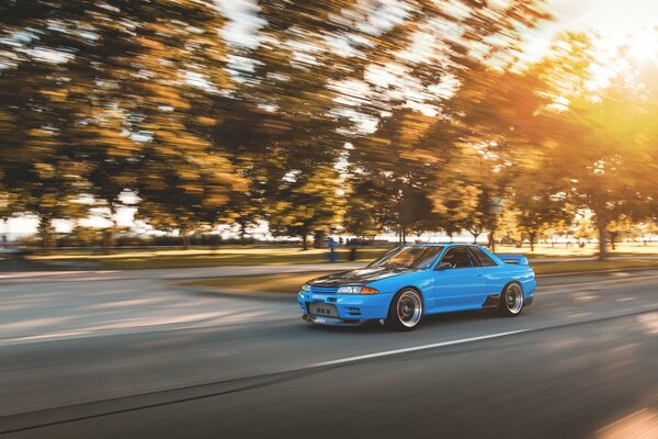 Blue car in the sun on the highway