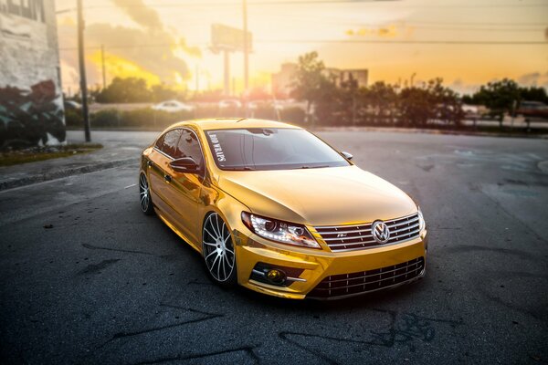 Golden Volkswagen on the background of sunset