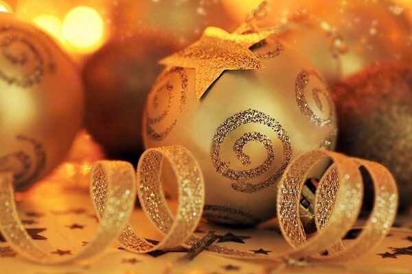 Several golden Christmas balls with a twisted ribbon