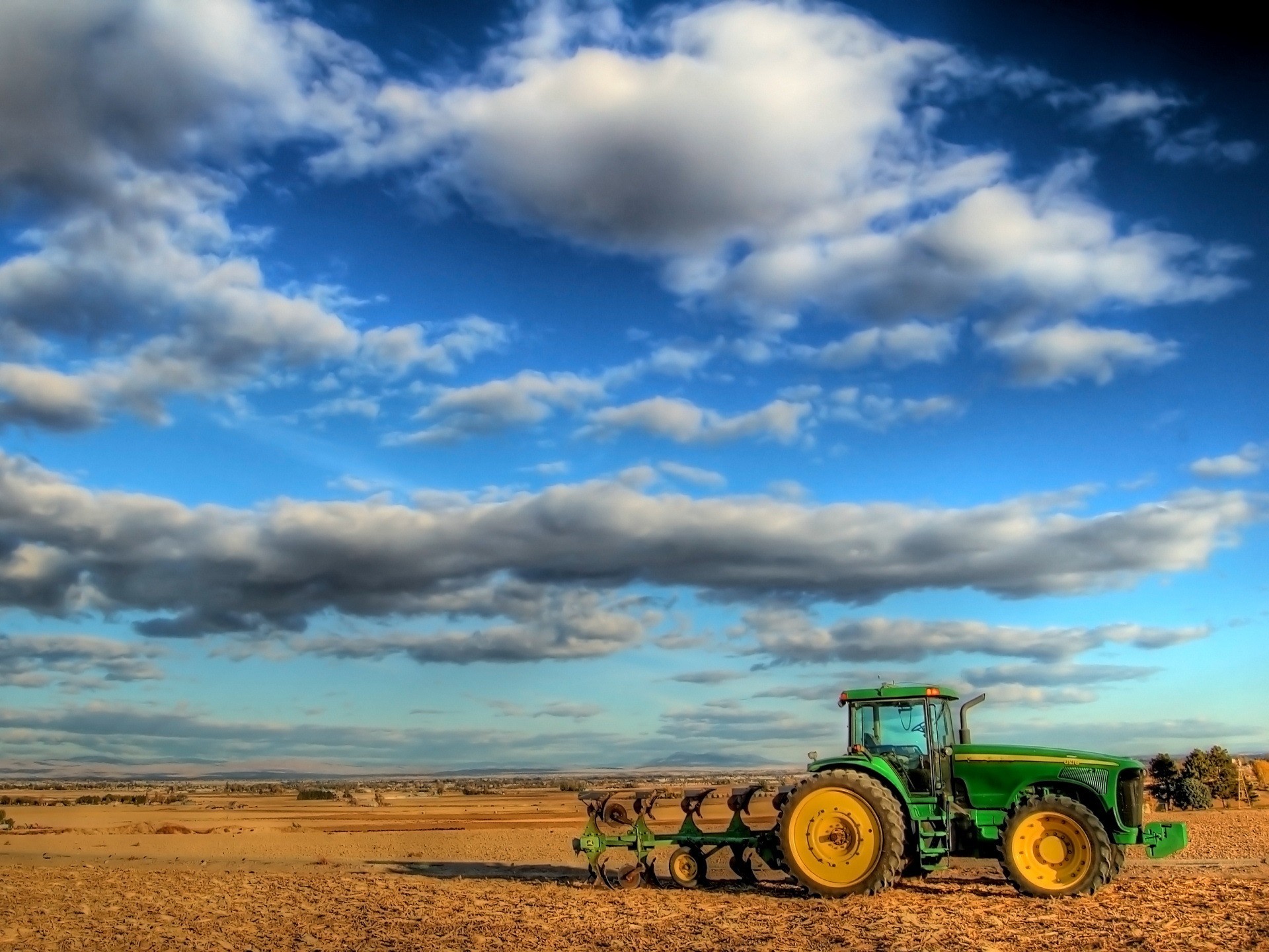 clouds the field tractor