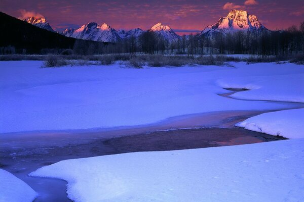 Winter creek and four mountains in the distance