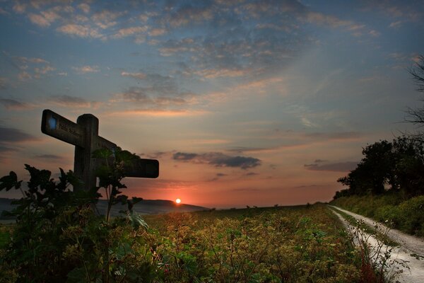 Signpost by the road at sunset
