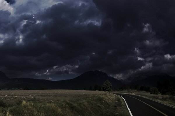 Clouds approaching the earth road mountains