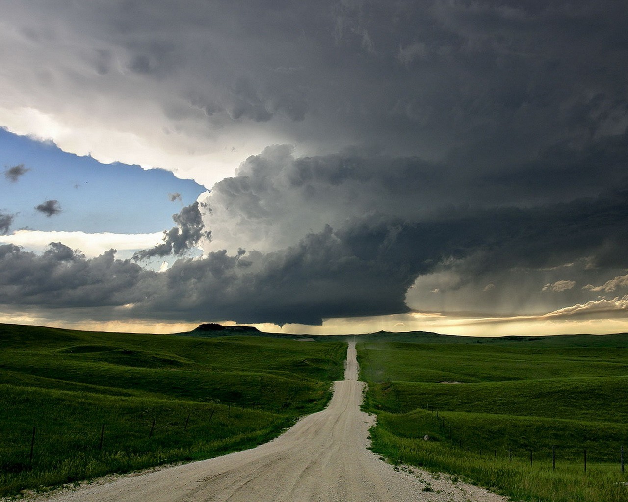 road clouds hills green