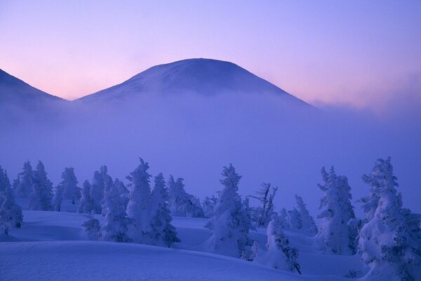 Fog and clouds in snowy mountains