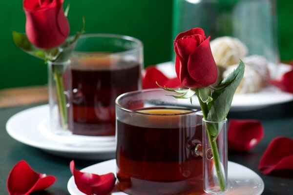 Two mugs of tea and red roses