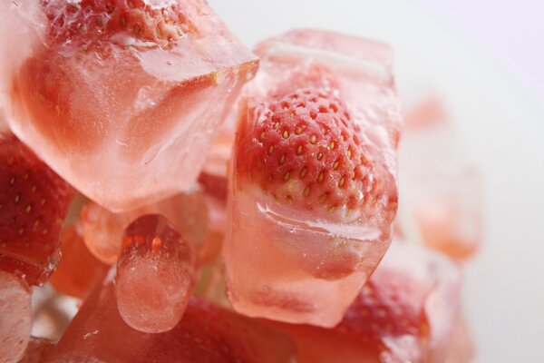 Strawberries frozen in pieces of ice