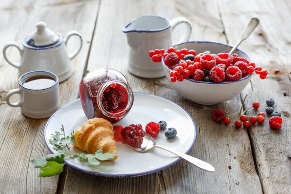 Croissant for breakfast with berries and jam