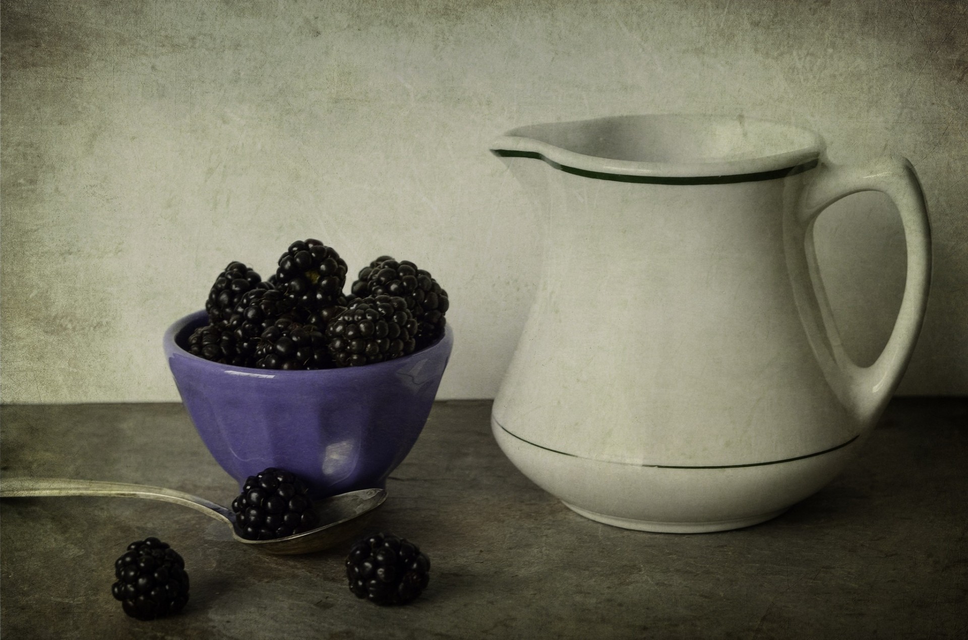 blackberry berries spoon style bowl lilac pitcher table white