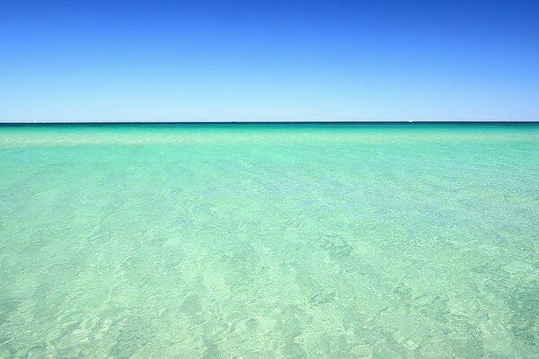 The sea is azure water stretching into the distance beyond the horizon