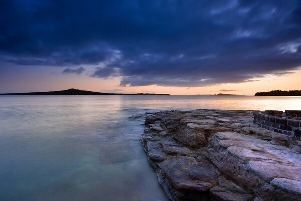 View of the evening bay from the rocky shore