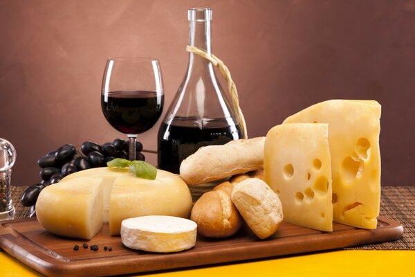 Composition with cheese, wine glass on the table