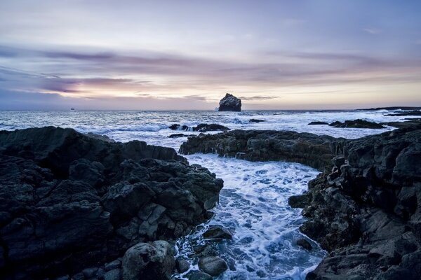 Black rocks and blue sea