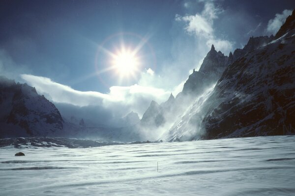 Chmury i słońce w zimnych górach. Roux