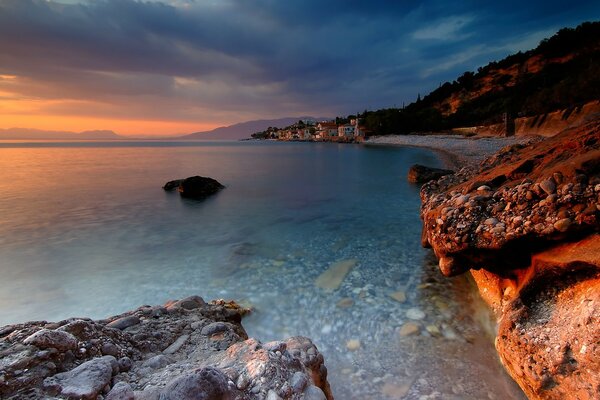 Clear lake, shore at sunset, crystal water