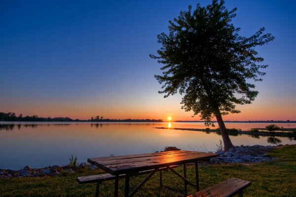 Wooden table on the lake shore