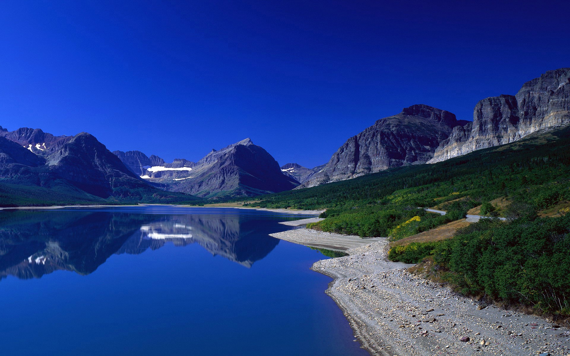 mountain water reflection beach grass sky