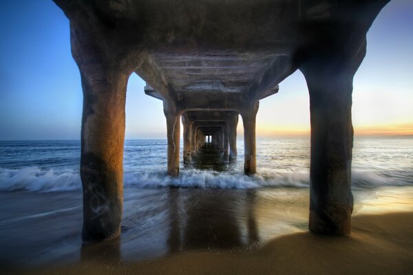 Pillars from the pier to the seashore