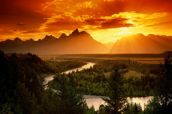 Fiery sunset in the mountains overlooking the river