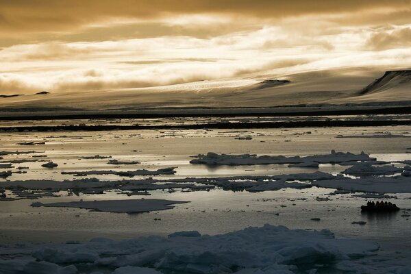 The ice melts on the river. Yellow sky