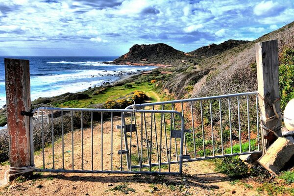 An old rusty gate by the shore