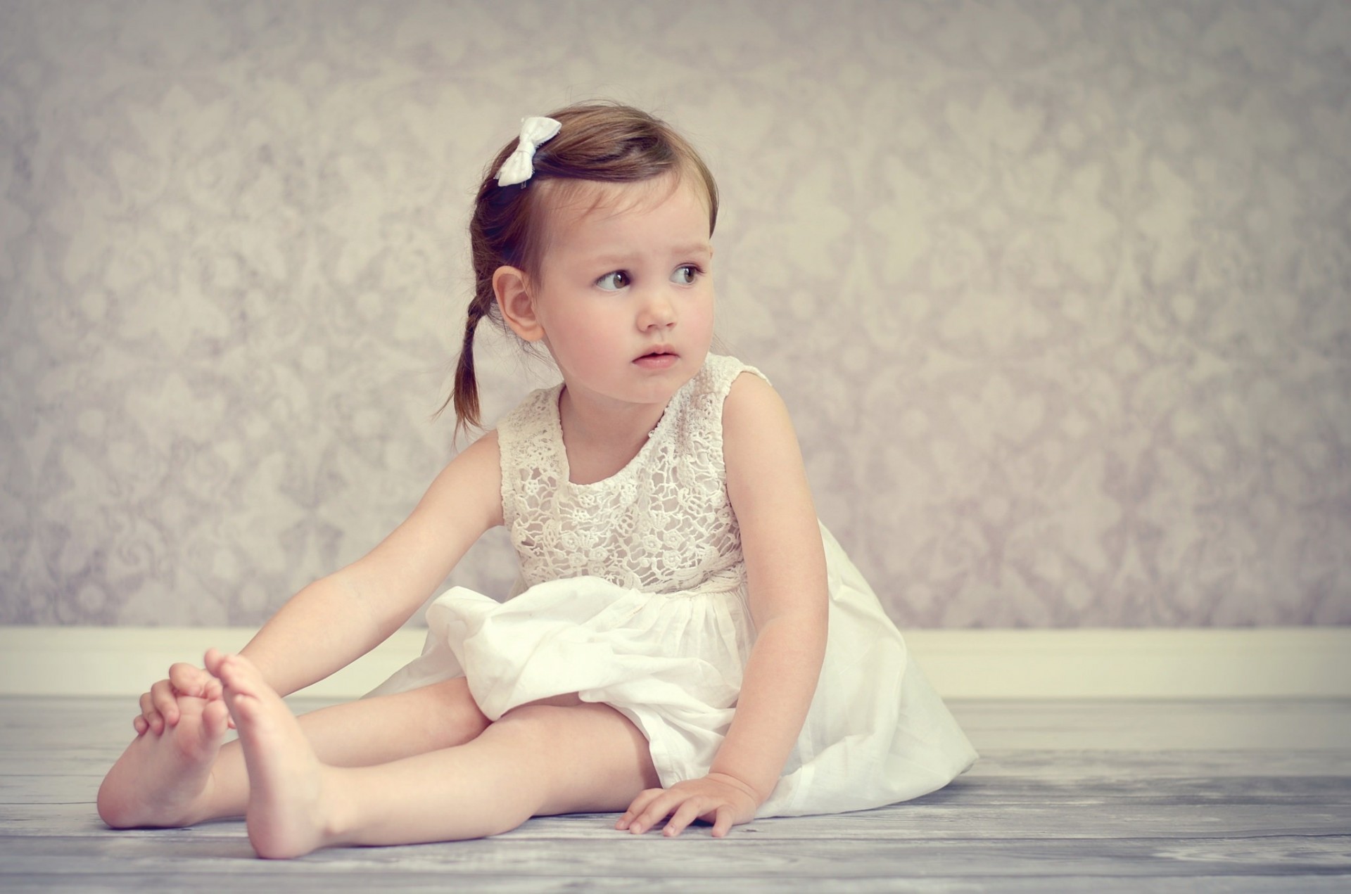 itting girl on the floor dress barefoot child mood