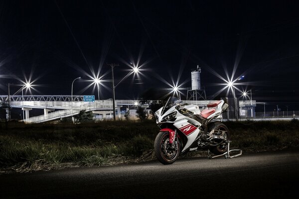 Red and white motorcycle in the lights of the night city