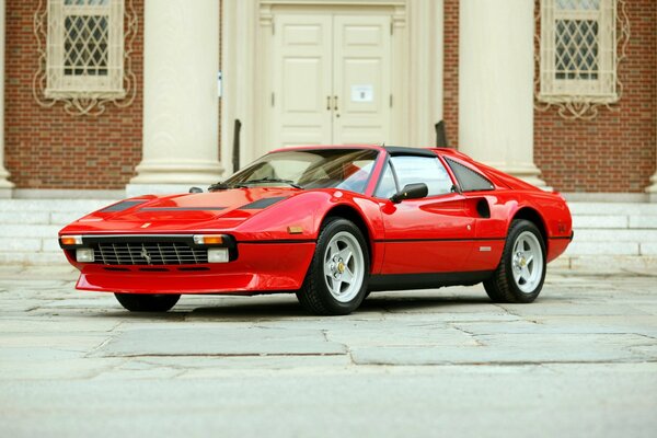 Classic Ferrari on the background of the entrance to the house