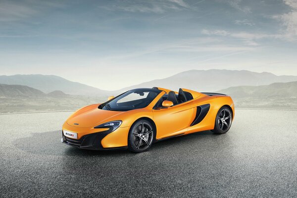 Orange McLaren, photo on the background of mountains