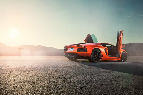 Orange lamborghini aventador lp 700-4 on sunrise background