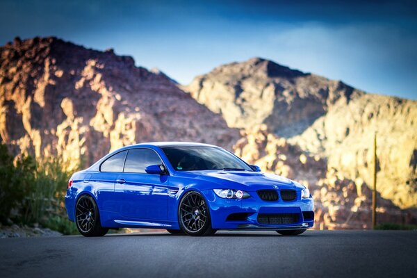 Blue BMW in daylight in the mountains