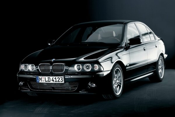 Black bmw in a dark room