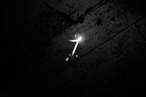 The number seven on a dark wood background