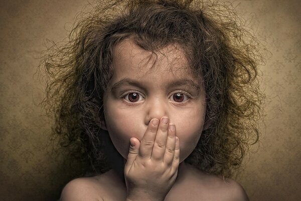 A very surprised curly-haired baby