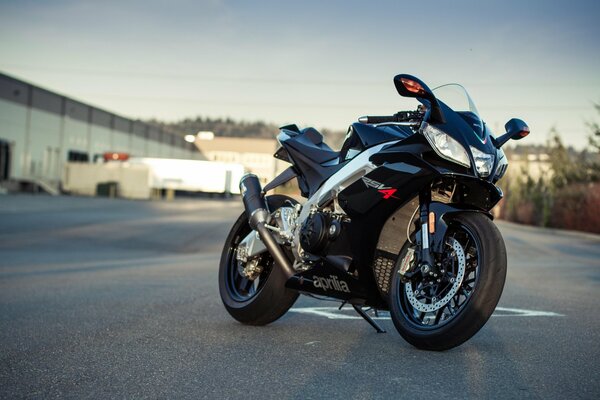 Black motorcycle on the background of the sky and the road