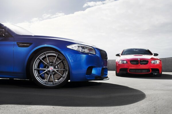 Two cars blue and red bmw m5 f10, m3, e92
