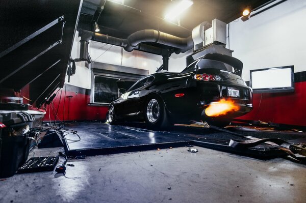 Toyota supra in the garage with flames from the exhaust pipe