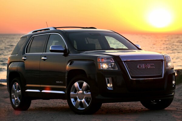 Beautiful black jeep with silver wheels on the background of the setting sun