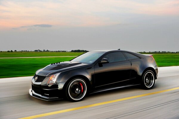 Black cadillac car in motion