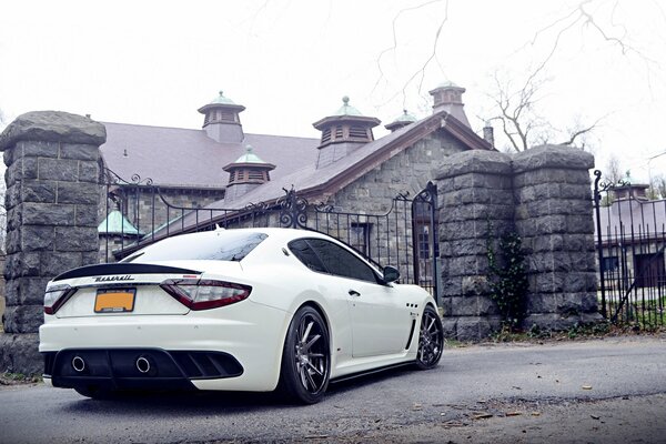 White tuned Maserati in the middle of the street