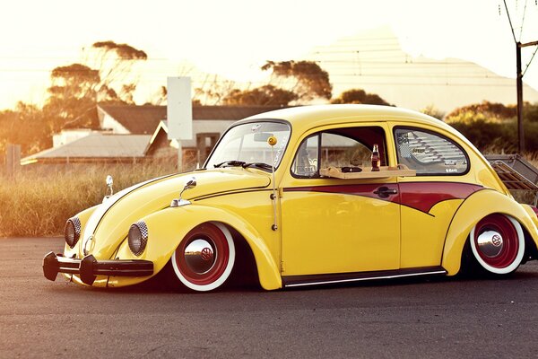 Retro photo of a yellow Volkswagen in the steppe