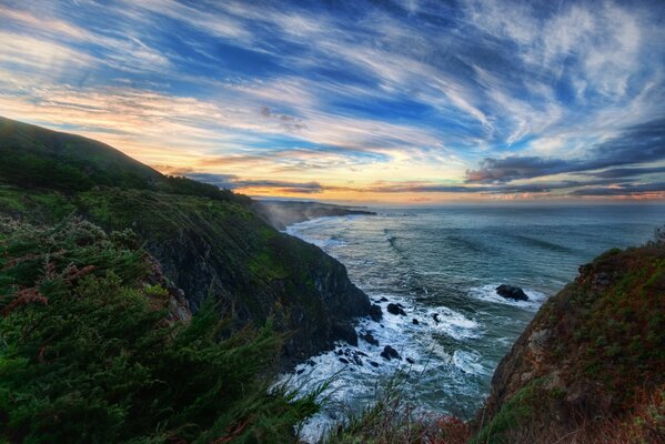 Cloudy morning by the raging sea