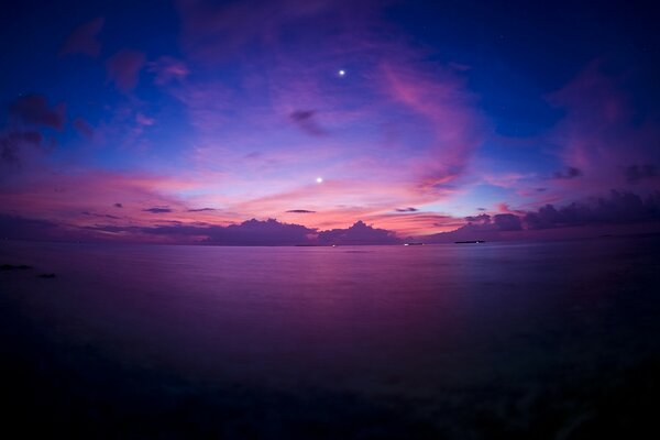 Purple sunset in the evening on the seashore