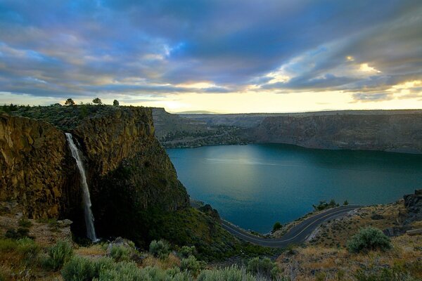 Waterfall in a rocky plateau on the lake shore