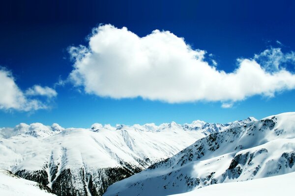 Conquered snowy peak in the clouds