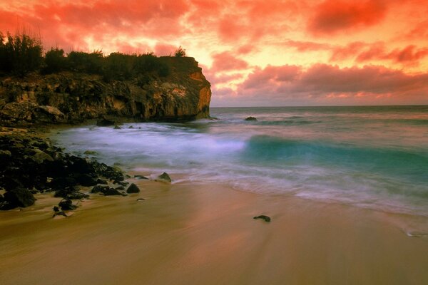 Sunset on the beach rocks and sea