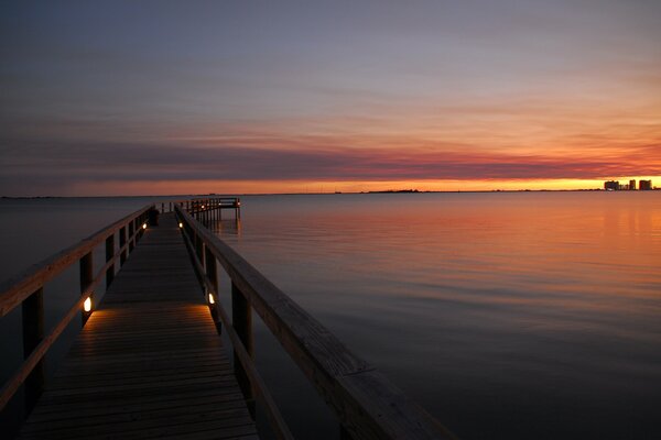 Gorgeous sunset on the bridge in the sea