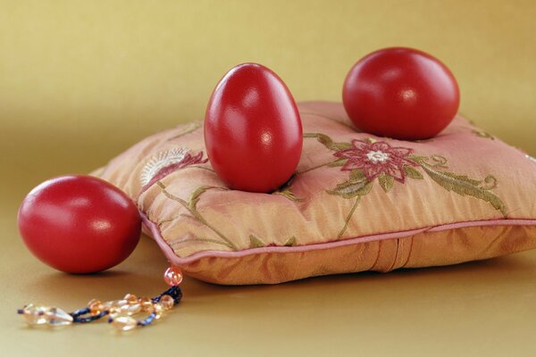 Easter red eggs on a pillow