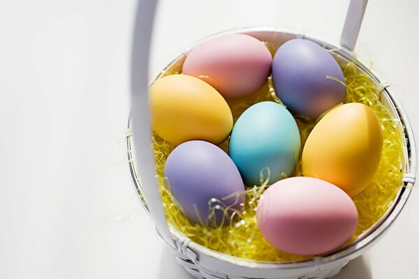 White basket with colored eggs